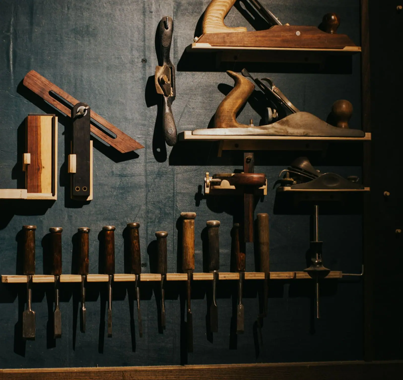 Woodworking hand tools hung on a workshop wall